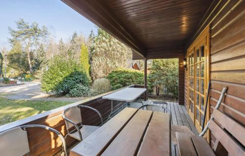 a wooden bench on the porch of a house at Pet Friendly Home In Haren With Wifi in Haren