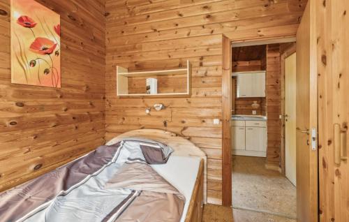 a bed in a room with wooden walls at Pet Friendly Home In Haren With Wifi in Haren
