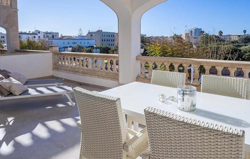 a white table and chairs on a balcony at Primavera in Colònia De Sant Jordi