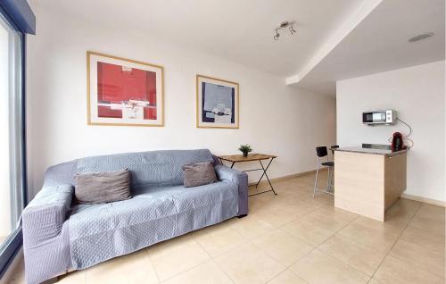 a living room with a couch and a table at 2 Bedroom Awesome Apartment In Moncofa in Moncófar