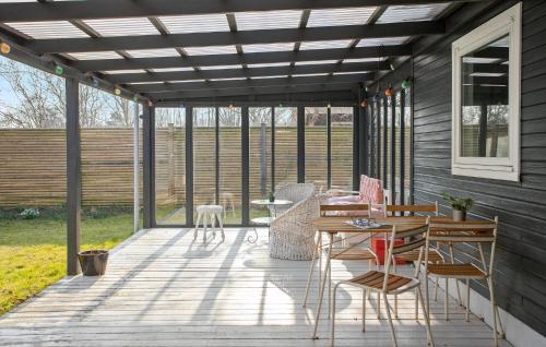 a pergola on a deck with a table and chairs at 3 Bedroom Pet Friendly Home In Korsør in Korsør