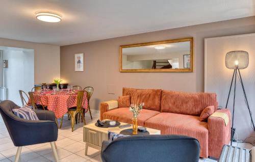 a living room with a couch and a table at Lovely Home In Hauteville-Sur-Mer in Hauteville-sur-Mer