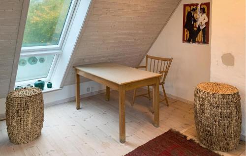 a table and chairs in a room with a window at 2 Bedroom Stunning Home In Tranekær in Tranekær