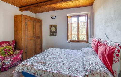 a bedroom with a bed and a chair and a window at 1 Bedroom Beautiful Apartment In Sorano in Sorano