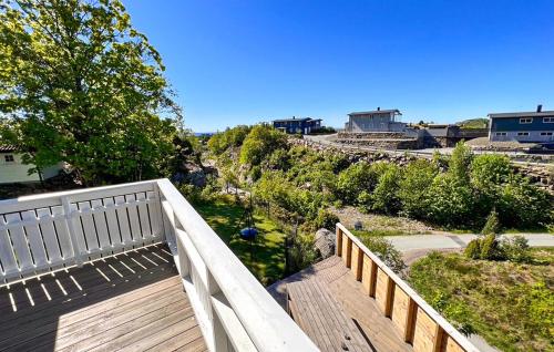 a wooden balcony with a view of a yard at 4 Bedroom Cozy Home In Lindesnes in Svenevik