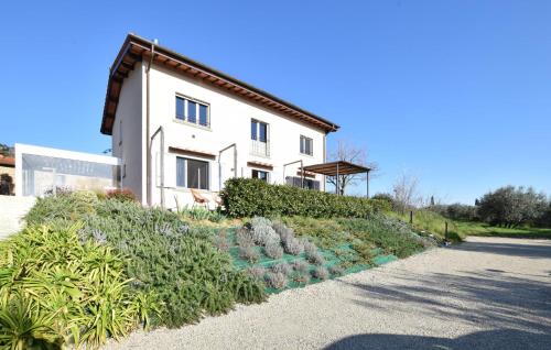 a white house with a garden in front of it at Nice Apartment In Terranuova Bracciolini in Terranuova Bracciolini