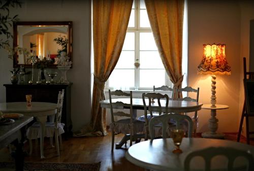a dining room with a table and chairs and a window at Zámek Napajedla in Napajedla