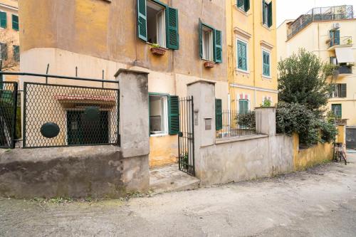 an old building with green shutters and a gate at San Pietro Apartment 66 in Rome