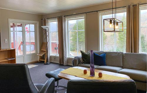a living room with a couch and a table at 3 Bedroom Amazing Home In Haddal in Haddal
