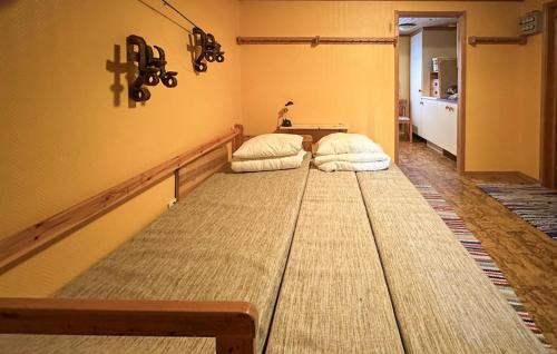 a large bed in a room with two pillows on it at Beautiful Home In Jordet With Sauna in Jordet