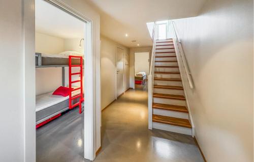 a room with two bunk beds and a staircase at 3 Bedroom Awesome Apartment In Søgne in Søgne