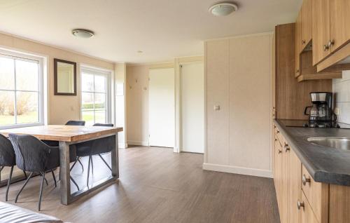 a kitchen with a table and chairs in a room at 2 Bedroom Stunning Home In Wagenborgen in Wagenborgen