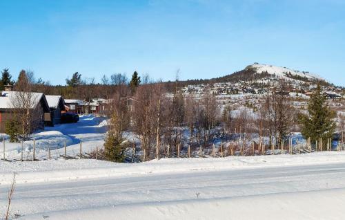 a snow covered road with a mountain in the background at 3 Bedroom Beautiful Apartment In Gol in Gol