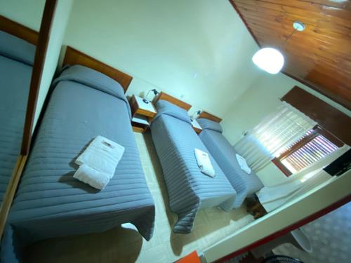 a bedroom with a blue bed in a room at Hotel Punto Sur Avenida in Malargüe
