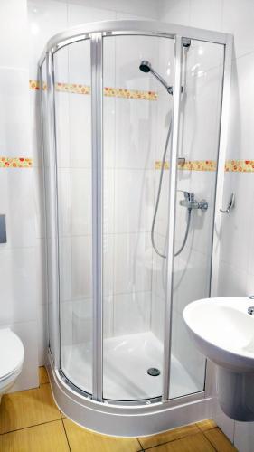 a shower with a glass door in a bathroom at Jaś i Małgosia nad Jeziorem Wigry in Rosochaty Róg