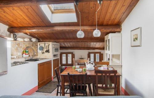 a kitchen with a wooden table and some chairs at 1 Bedroom Stunning Apartment In Sorano in Sorano