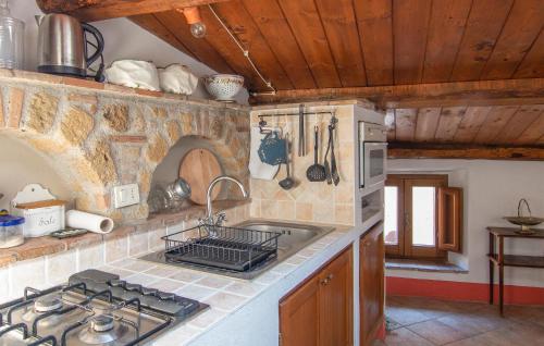 a kitchen with a sink and a stove top oven at 1 Bedroom Stunning Apartment In Sorano in Sorano