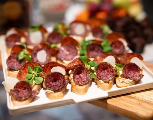 a plate of mini sandwiches with meatballs and cheese at Radisson Hotel Budapest BudaPart in Budapest