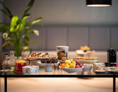 a table with different types of food on it at Radisson Hotel Budapest BudaPart in Budapest