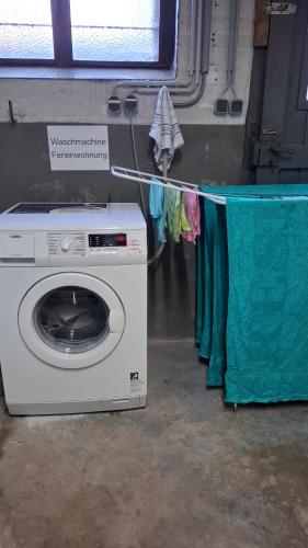 a washing machine and a clothes line with clothes at Speelberger Oase in Speelberg