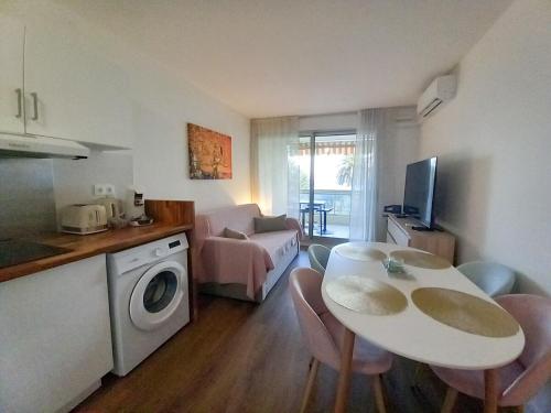 a kitchen and a living room with a table and chairs at Dionysos in Cannes