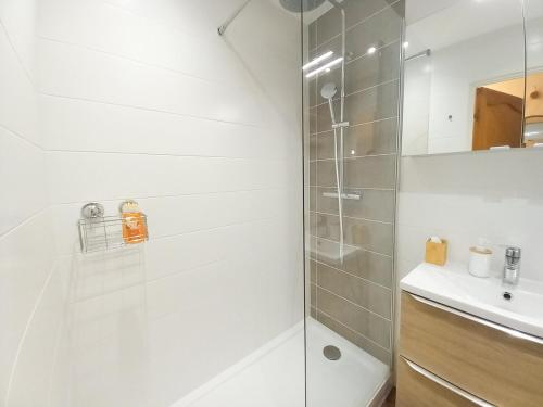 a white bathroom with a shower and a sink at Dionysos in Cannes