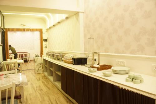 a kitchen with a counter with plates on it at Subhash Hotel in Prayagraj