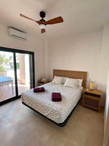 a bedroom with a bed with a ceiling fan at El oasis Monaco - 3 chambres in Fuente-Álamo de Murcia