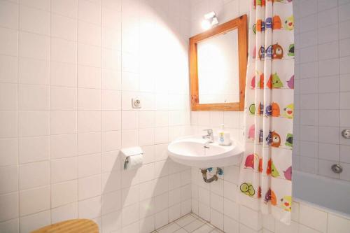a bathroom with a sink and a shower curtain at Apartment with beautiful views - Muralla0218 in Calpe