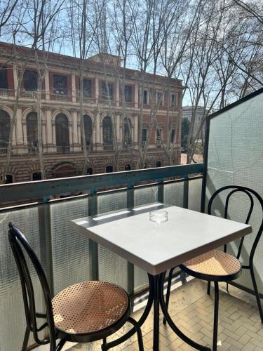 a table and chairs on a balcony with a building at Guest House Esty in Rome