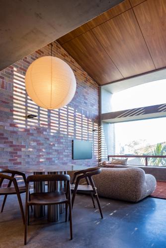 a living room with a table and chairs and a tv at Camperdown - Luxury Architectural Escape in Sydney