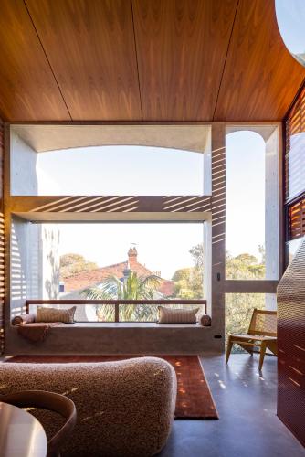 a living room with a large window and a couch at Camperdown - Luxury Architectural Escape in Sydney