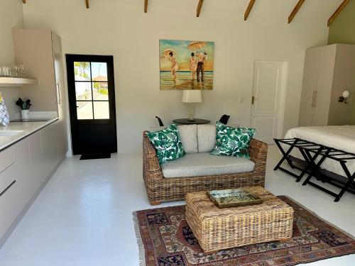 a living room with a couch and a chair at The Cottage at Paradise Found in Yzerfontein