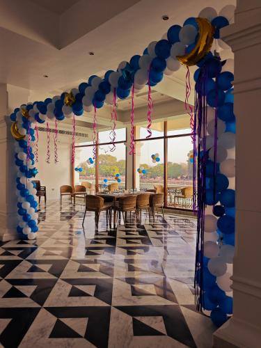a room with a table with blue and white balloons at Gauri Gangaa in Haridwār