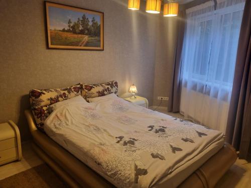 a bedroom with a bed with a blanket on it at LivingPalanga - S. Neries in Palanga