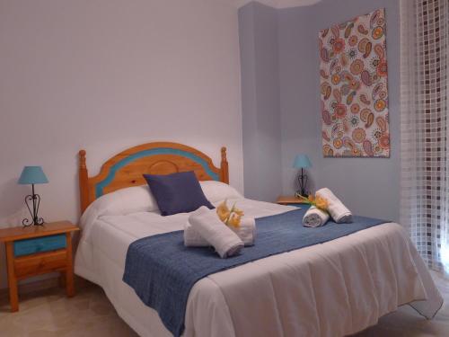 a bedroom with a bed with two pillows on it at Hostel Conil in Conil de la Frontera