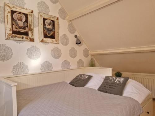 a bedroom with a bed with two pillows on it at VakantieStudio 88 in Kamperland