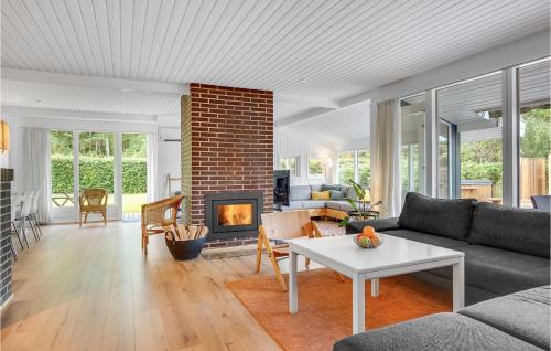 a living room with a couch and a fireplace at Three-Bedroom Holiday Home In Ebeltoft in Ebeltoft