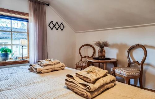 a bedroom with two beds with towels on them at Ekebo in Åsensbruk