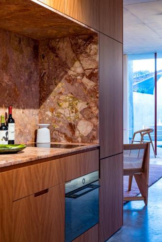 a kitchen with a counter top and a table at Camperdown- Luxury Architectural Apartment Escape in Sydney