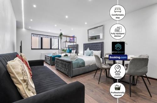 a bedroom with a bed and a couch and a table at Stylish Studio Apt By Stay Smart Short Lets & Serviced Accommodation Golders Green With Free WiFi in London
