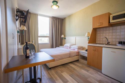 a hotel room with a bed and a sink at Marom Residence Romema in Haifa