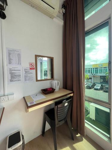 a desk in a room with a window at Hotel Jc 118 Sdn Bhd in Sandakan