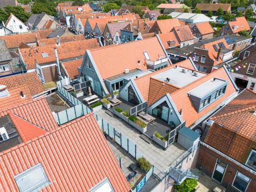 an aerial view of a city with roofs at Weststraat 22 - Ouddorp - Appartement West 3P in Ouddorp