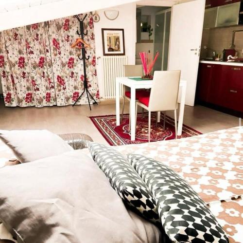 a bedroom with a bed and a table with a chair at Dimora Criosa b&b in Ruvo di Puglia