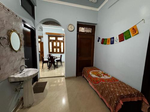 a bedroom with a bed and a sink in a room at Vedic Stays Haridwar in Haridwār