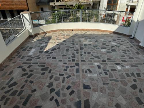 a walkway with a mosaic floor in a building at Vedic Stays Haridwar in Haridwār