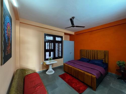 a bedroom with a bed and a window at Vedic Stays Haridwar in Haridwār