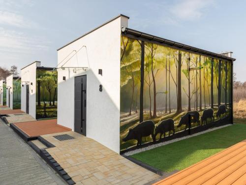 a mural of sheep on the side of a building at Hotel Kozerki in Kozerki