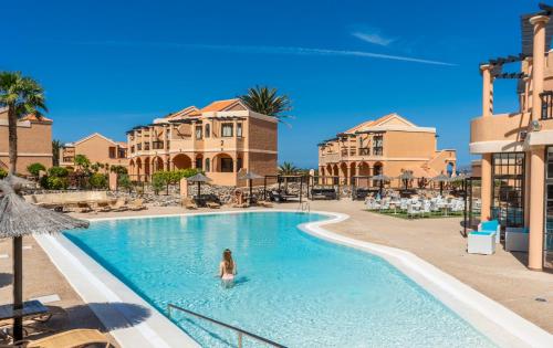 a woman in a swimming pool at a resort at Bakour Fuerteventura La Pared in La Pared